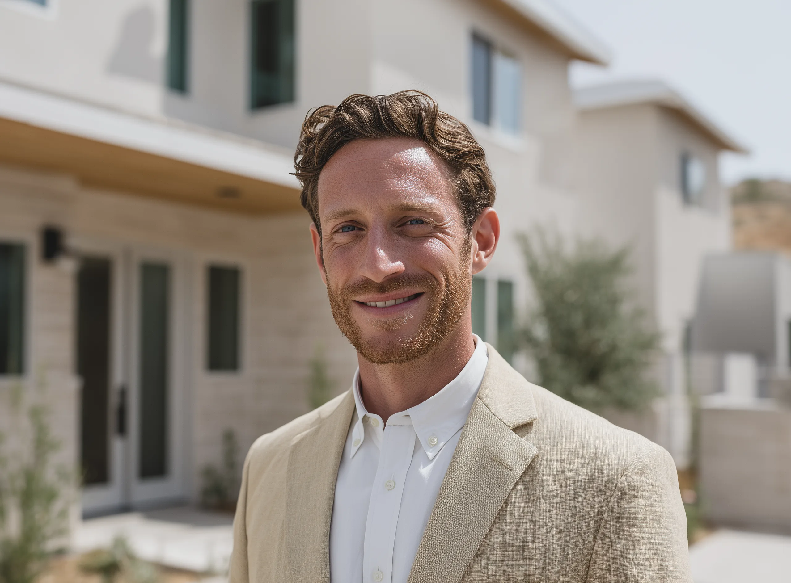 Portrait of Jonas Bone, Managing Partner at Revalto, in front of a modern home